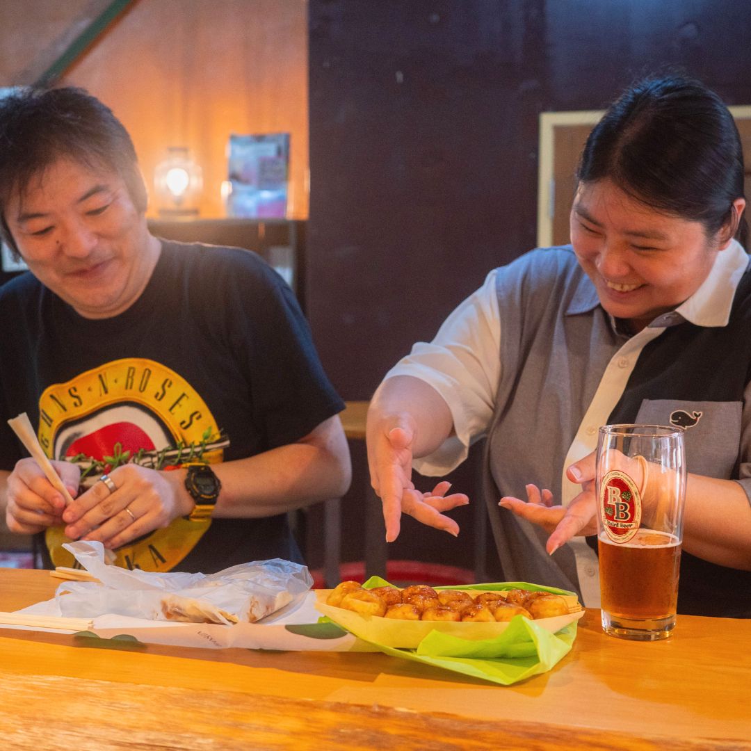 regular customers with takoyaki at Baird Base Station Kansai